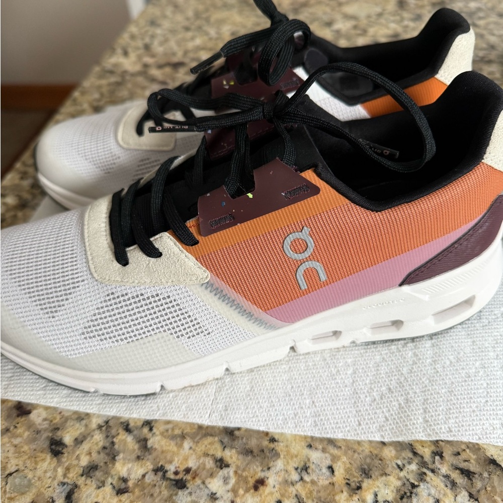 On Running White and Orange Athletic Shoes